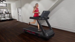 A woman in a red tank top is running on a treadmill